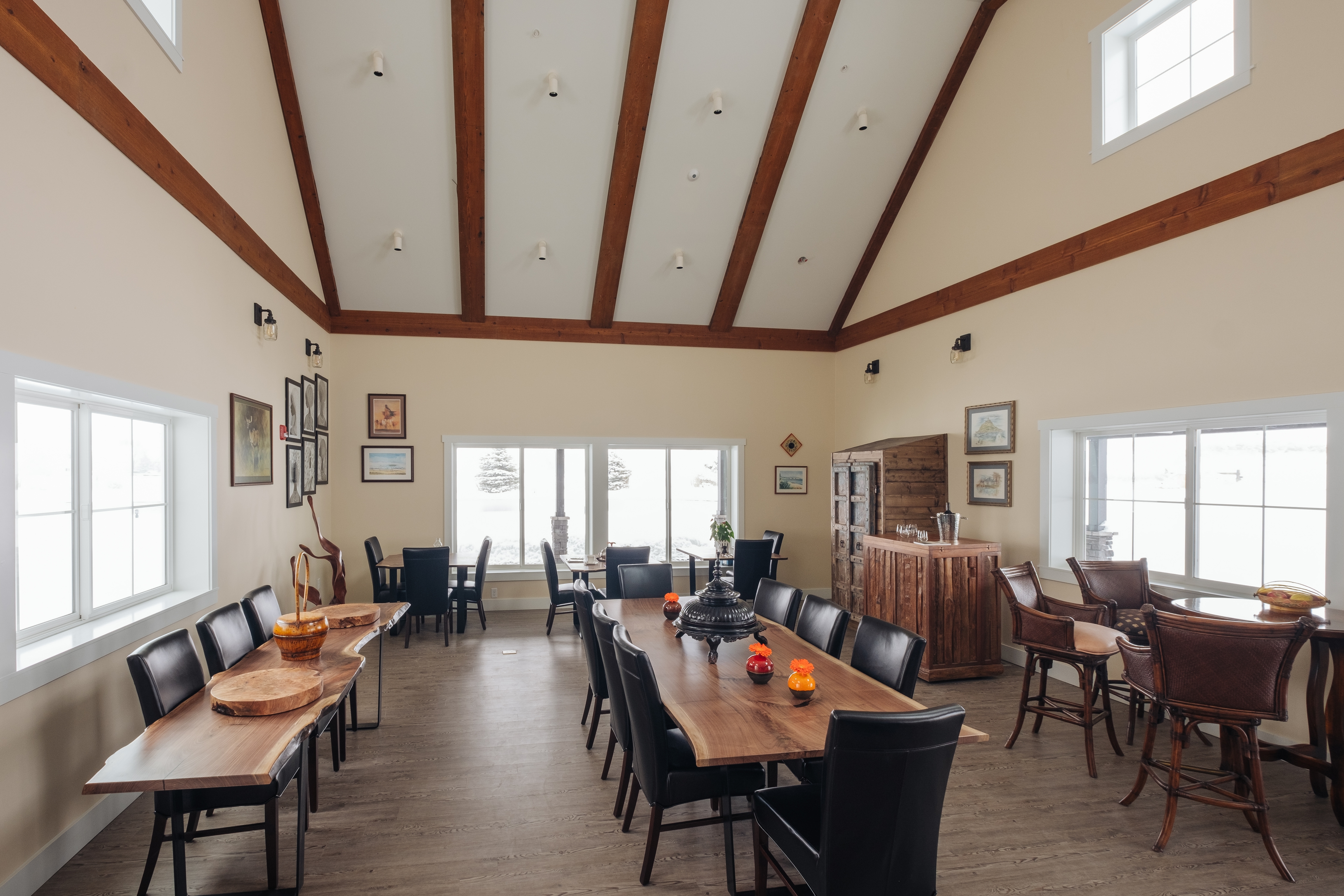 A view of the dining room with 30 ft high ceiling, a fireplace, board games, a library